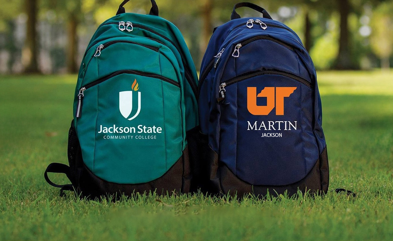 Jackson State Community College and University of Tennessee at Martin backpacks sitting side by side on grass