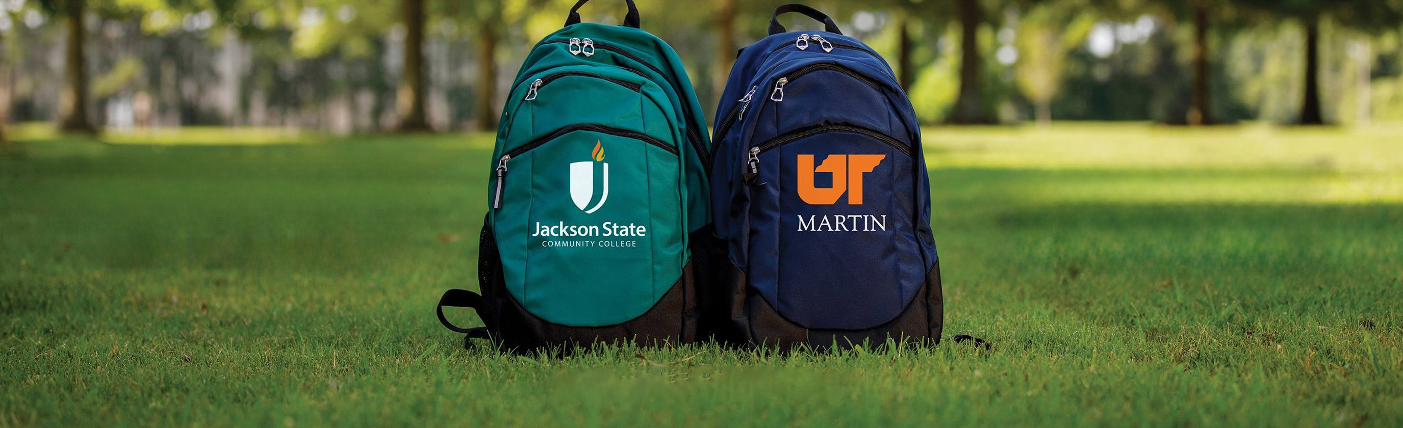 UT Martin and JSCC backpacks sitting side by side in grass