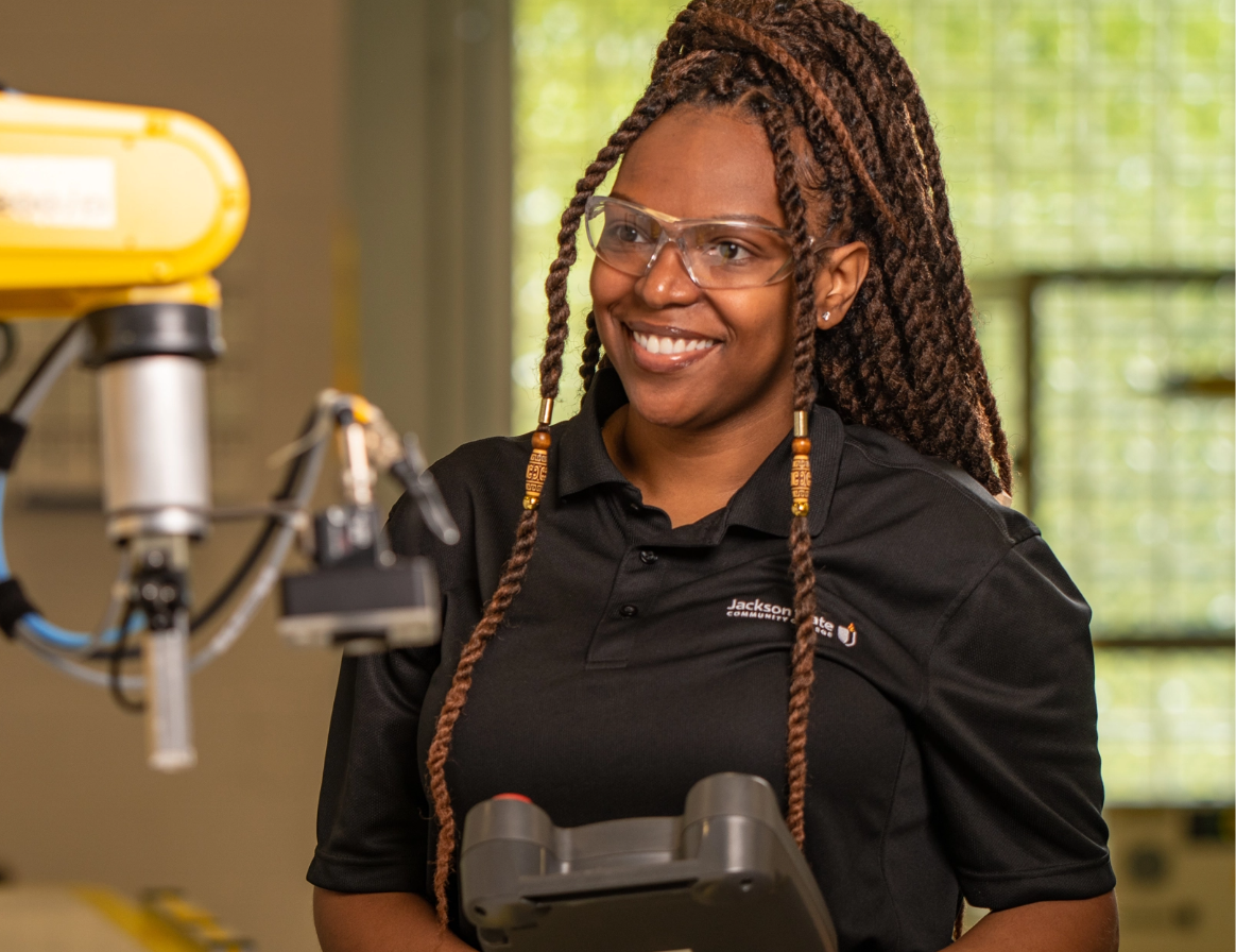 Woman wearing safety glasses operating machinery