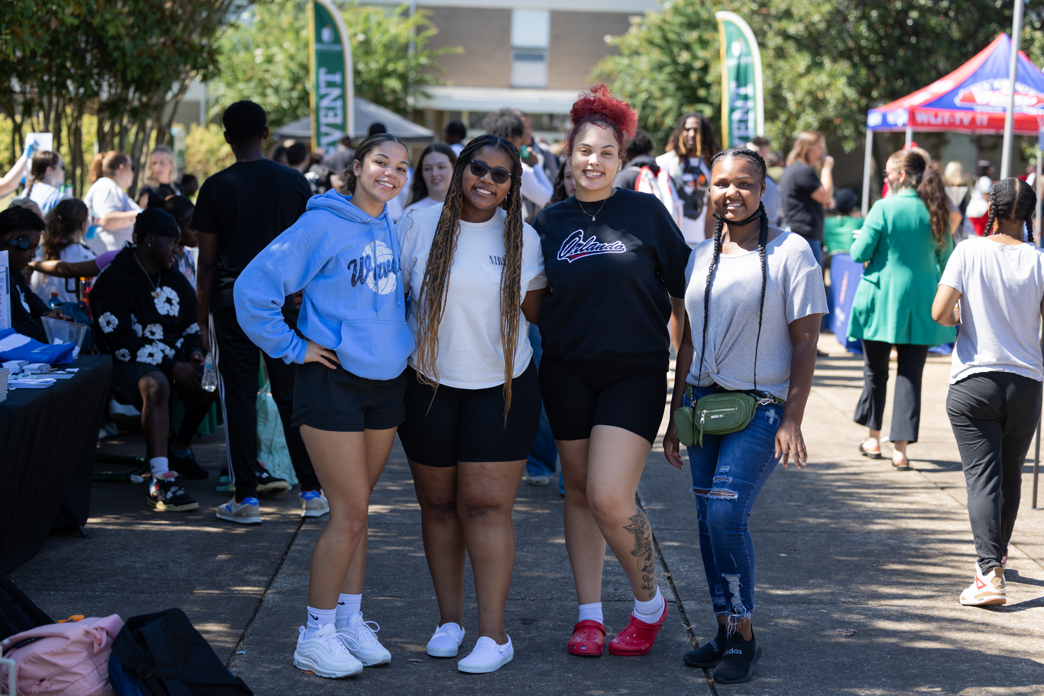 Four Students Standing together at a large college event on the Jackson State campus.